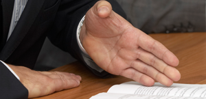 hands of someone speaking pointing to paper